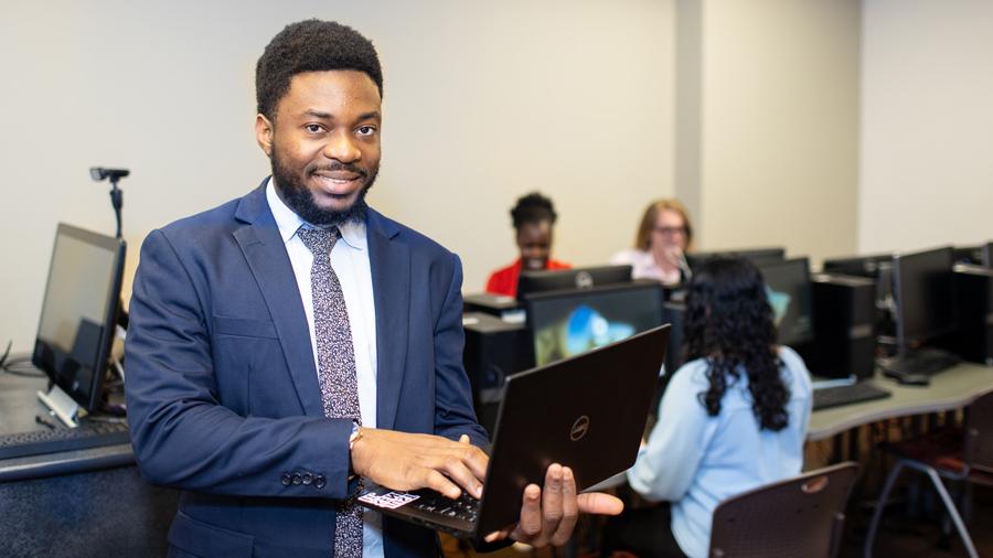 Student with laptop in computer lab